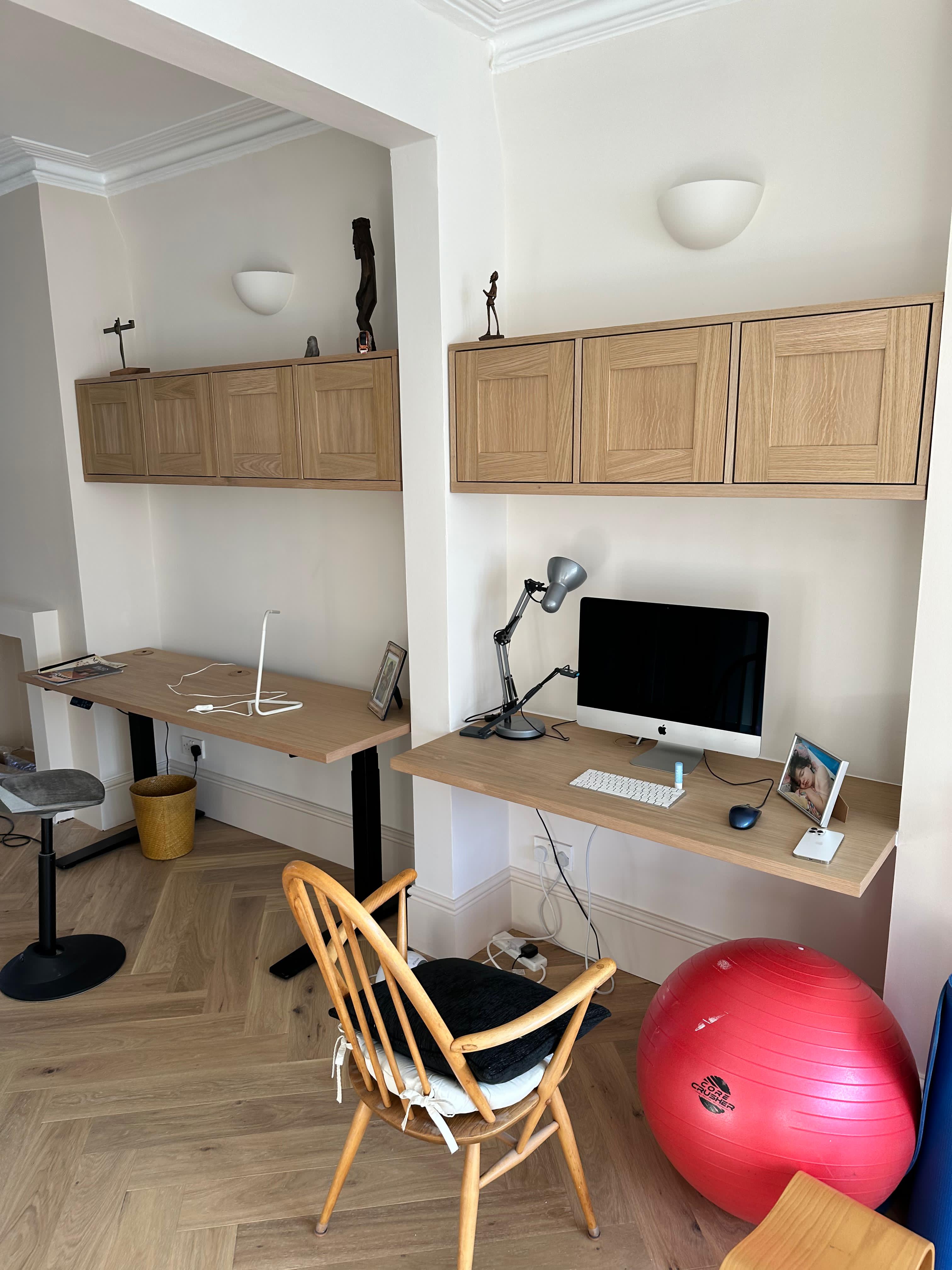 Custom oak home office with built-in desks and overhead cabinets